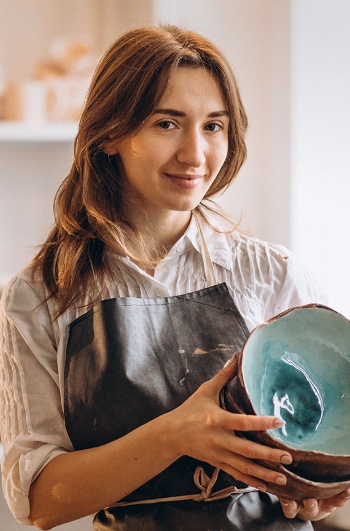 Craftswoman in pottery shop