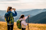 Mother and daughter looking through binoculars