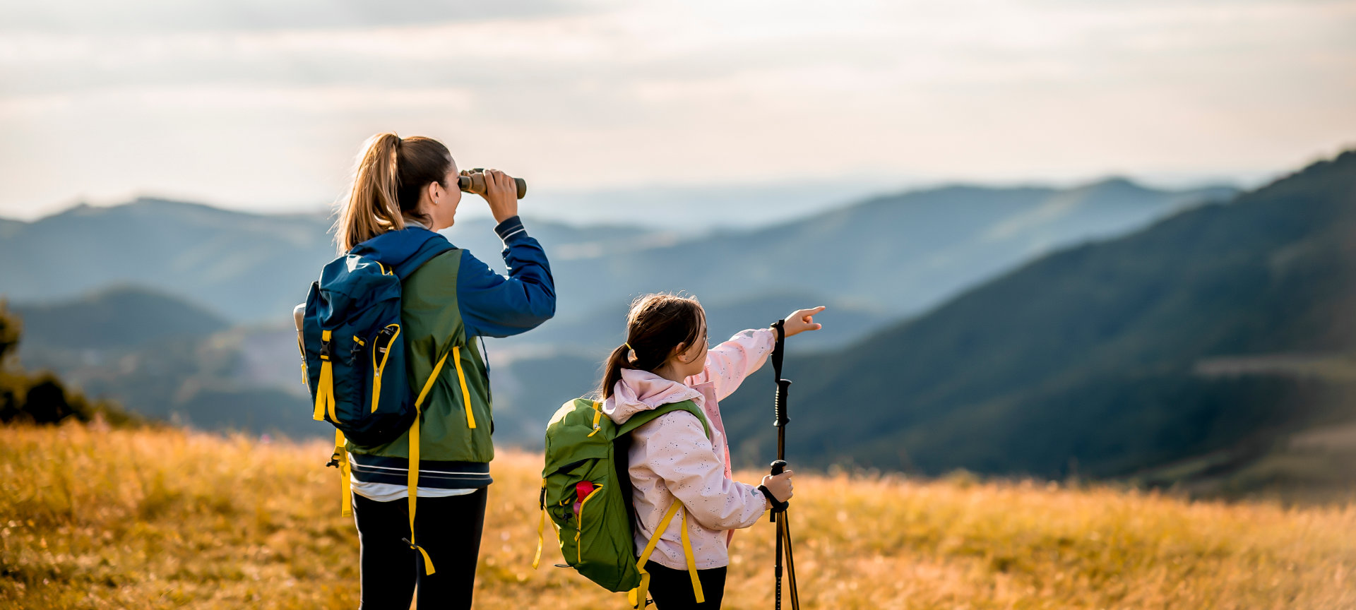 Mother and daughter looking through binoculars Mother and daughter looking through binoculars