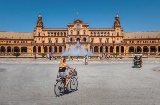 Tourists on bicycles in Plaza de España square in Seville, Andalusia