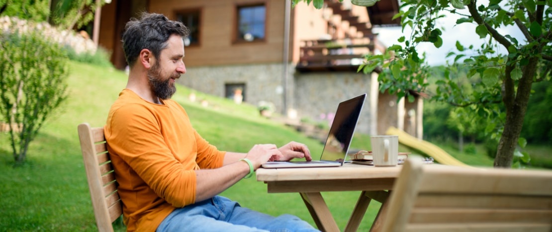 Eine Person arbeitet im Homeoffice in ländlicher Umgebung