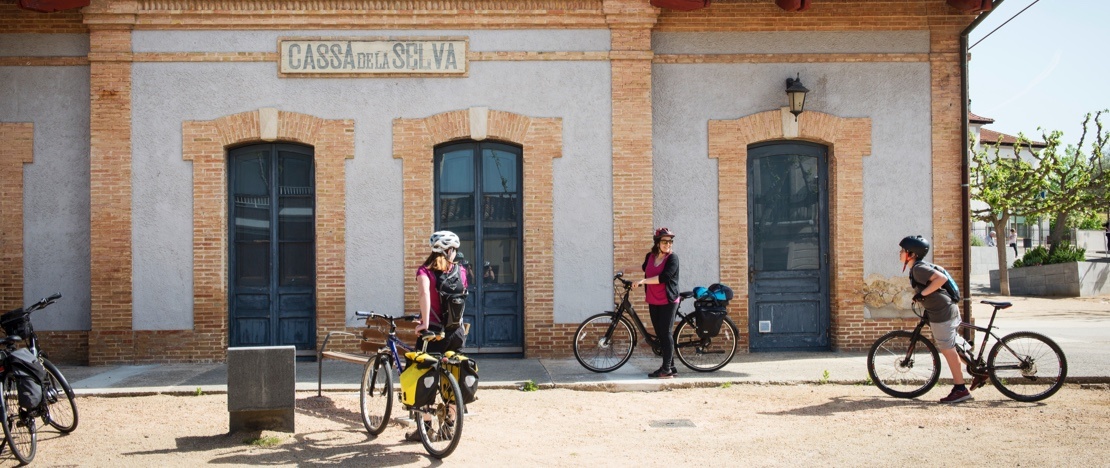 Cyclists resting in the old station of Cassà de la Selva, in Girona, Catalonia