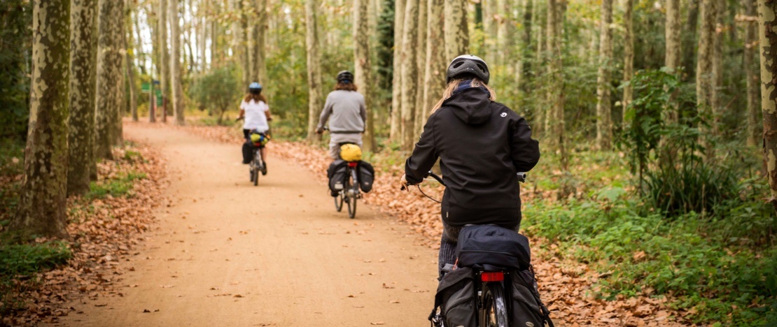 Cycle tourists on the El Carrilet Greenway in Girona, Catalonia